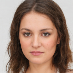 Joyful white young-adult female with long  brown hair and green eyes