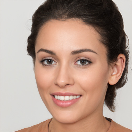 Joyful white young-adult female with medium  brown hair and brown eyes