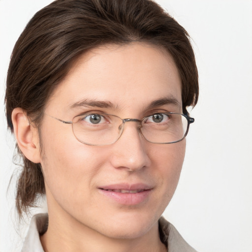 Joyful white young-adult female with short  brown hair and grey eyes