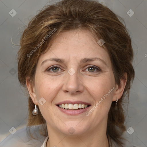 Joyful white adult female with medium  brown hair and grey eyes