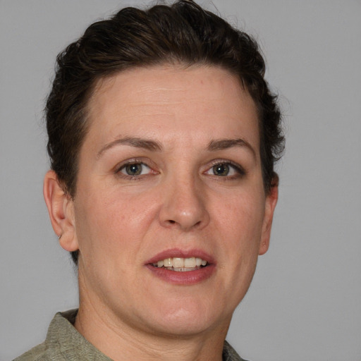 Joyful white adult female with short  brown hair and grey eyes