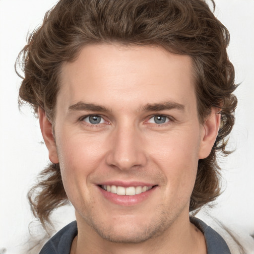 Joyful white young-adult male with medium  brown hair and brown eyes