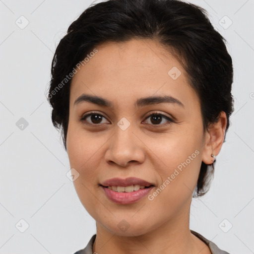 Joyful latino young-adult female with medium  brown hair and brown eyes