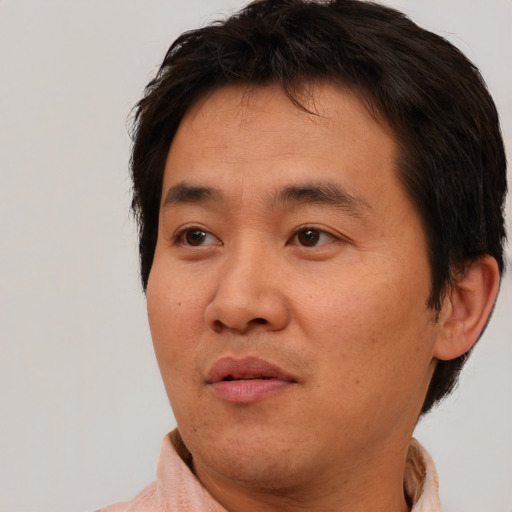 Neutral asian adult male with short  brown hair and brown eyes