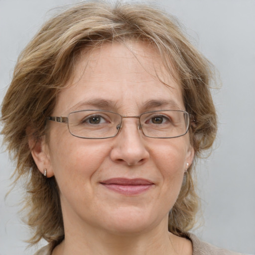 Joyful white middle-aged female with medium  brown hair and blue eyes