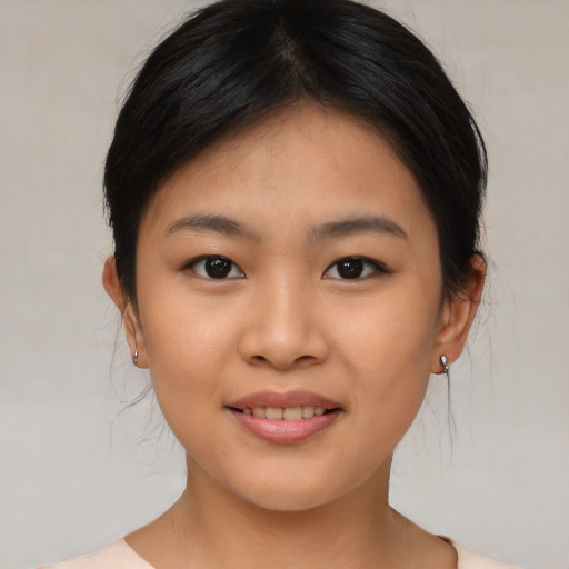 Joyful asian young-adult female with medium  brown hair and brown eyes
