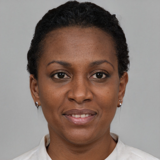 Joyful black adult female with short  brown hair and brown eyes