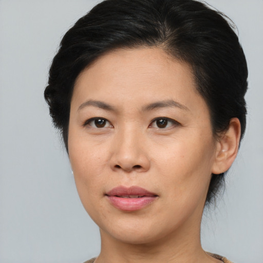 Joyful asian young-adult female with medium  brown hair and brown eyes