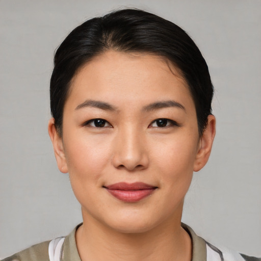 Joyful white young-adult female with short  black hair and brown eyes