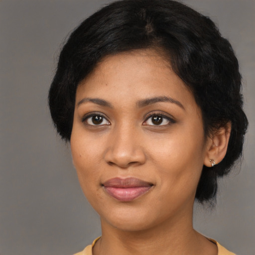 Joyful black young-adult female with medium  black hair and brown eyes