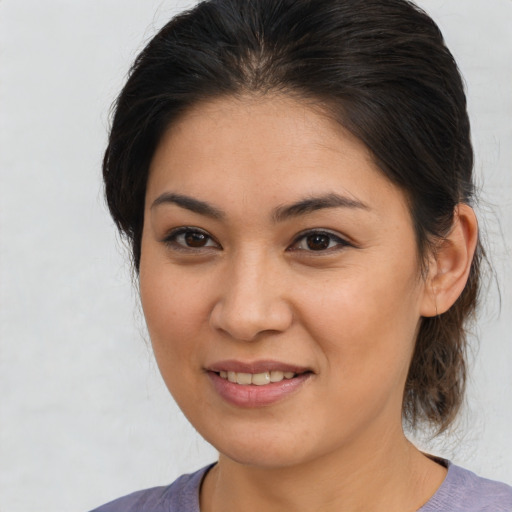 Joyful latino young-adult female with medium  brown hair and brown eyes