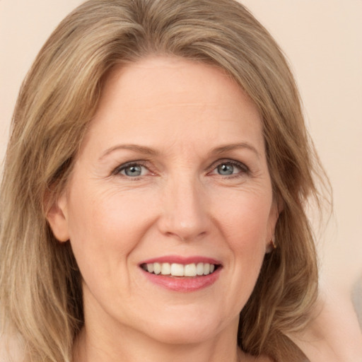 Joyful white adult female with medium  brown hair and green eyes