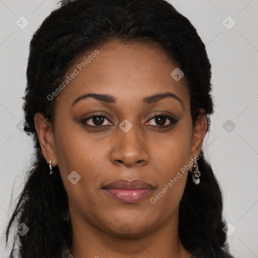 Joyful black adult female with long  brown hair and brown eyes