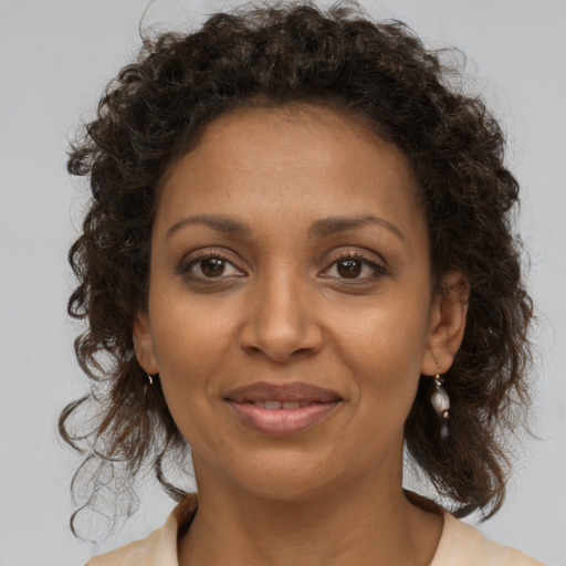 Joyful black young-adult female with medium  brown hair and brown eyes