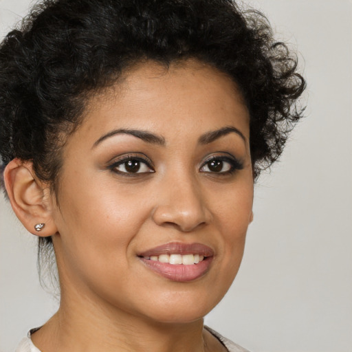 Joyful latino young-adult female with short  brown hair and brown eyes
