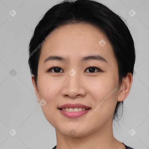 Joyful asian young-adult female with short  black hair and brown eyes