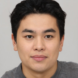 Joyful asian young-adult male with short  black hair and brown eyes