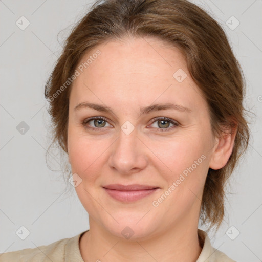 Joyful white young-adult female with medium  brown hair and green eyes