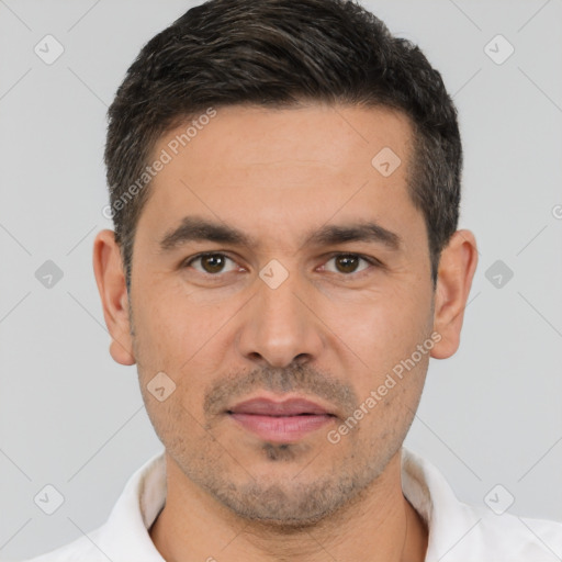 Joyful white young-adult male with short  black hair and brown eyes