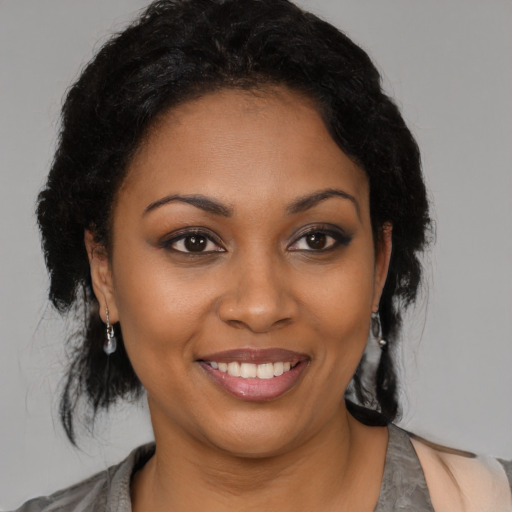 Joyful black young-adult female with medium  black hair and brown eyes