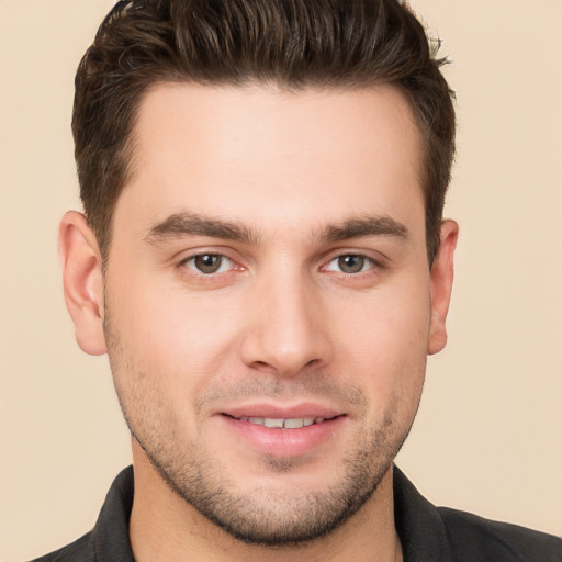 Joyful white young-adult male with short  brown hair and brown eyes