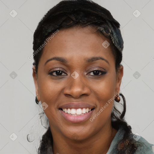 Joyful black young-adult female with long  brown hair and brown eyes