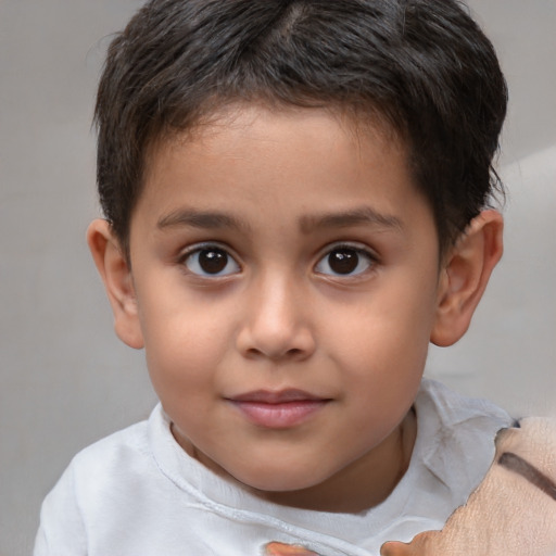 Joyful white child male with short  brown hair and brown eyes