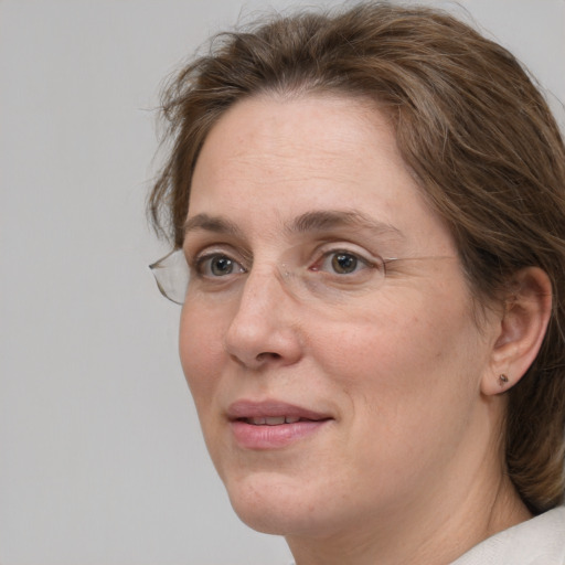 Joyful white adult female with medium  brown hair and grey eyes