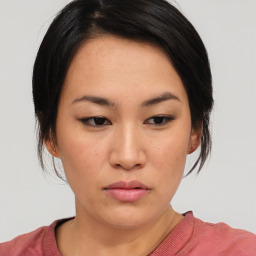 Neutral asian young-adult female with medium  brown hair and brown eyes