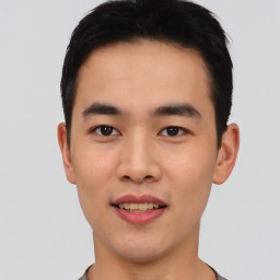 Joyful asian young-adult male with short  black hair and brown eyes