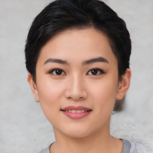 Joyful asian young-adult female with short  black hair and brown eyes