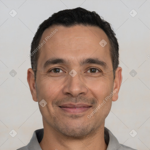 Joyful white adult male with short  black hair and brown eyes