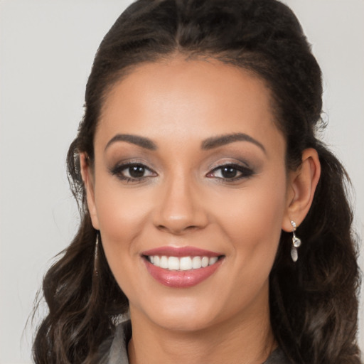 Joyful latino young-adult female with long  brown hair and brown eyes