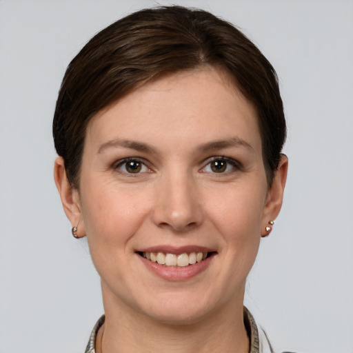 Joyful white young-adult female with short  brown hair and grey eyes