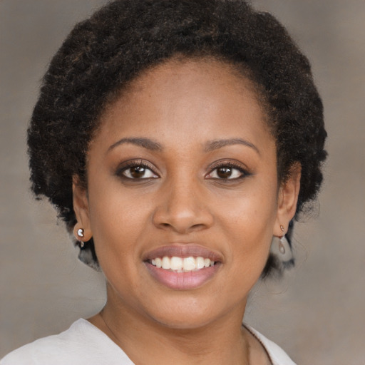 Joyful black young-adult female with short  brown hair and brown eyes