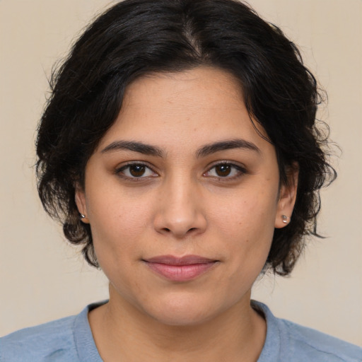 Joyful latino young-adult female with medium  brown hair and brown eyes