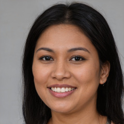 Joyful latino young-adult female with long  brown hair and brown eyes