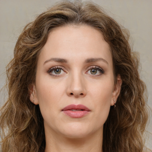 Joyful white young-adult female with long  brown hair and green eyes