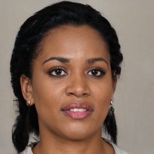 Joyful black young-adult female with medium  black hair and brown eyes
