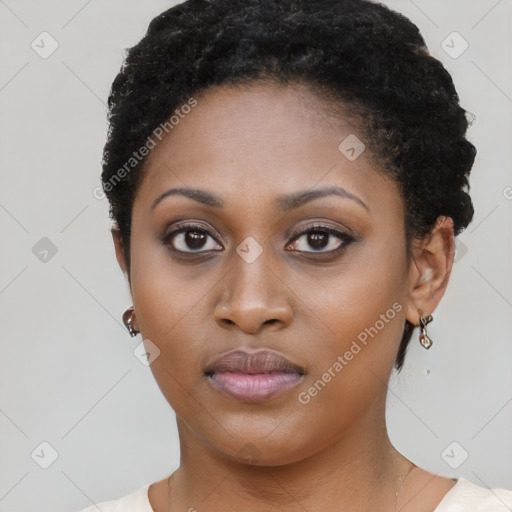 Joyful black young-adult female with short  brown hair and brown eyes