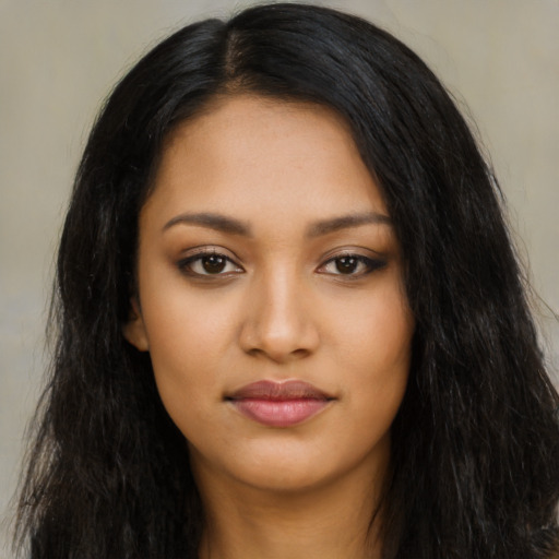 Joyful latino young-adult female with long  black hair and brown eyes