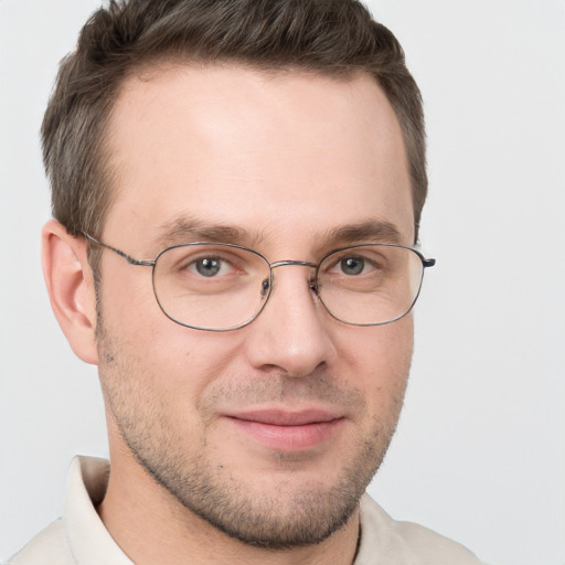 Joyful white adult male with short  brown hair and grey eyes