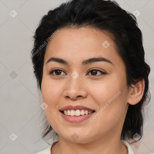 Joyful latino young-adult female with medium  brown hair and brown eyes