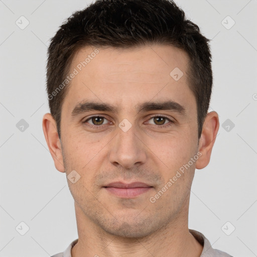 Joyful white young-adult male with short  brown hair and brown eyes