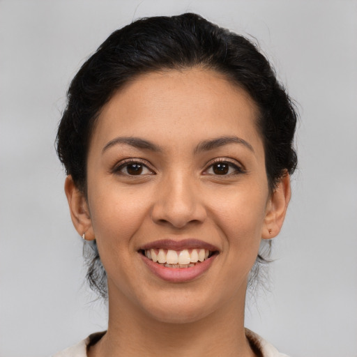 Joyful latino young-adult female with medium  brown hair and brown eyes