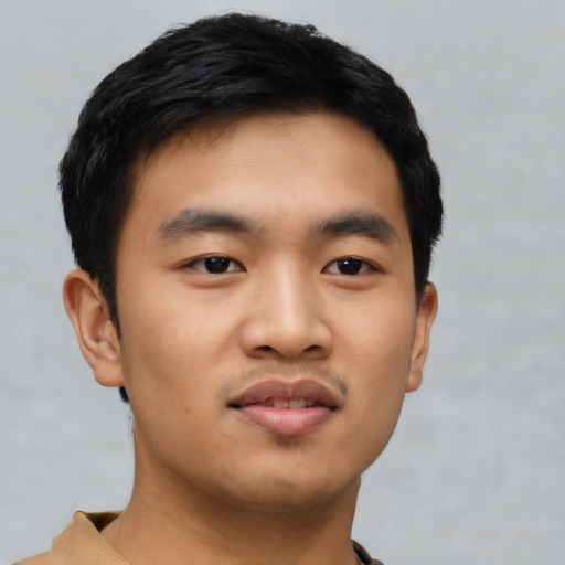 Joyful asian young-adult male with short  black hair and brown eyes