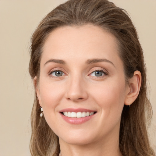 Joyful white young-adult female with long  brown hair and grey eyes