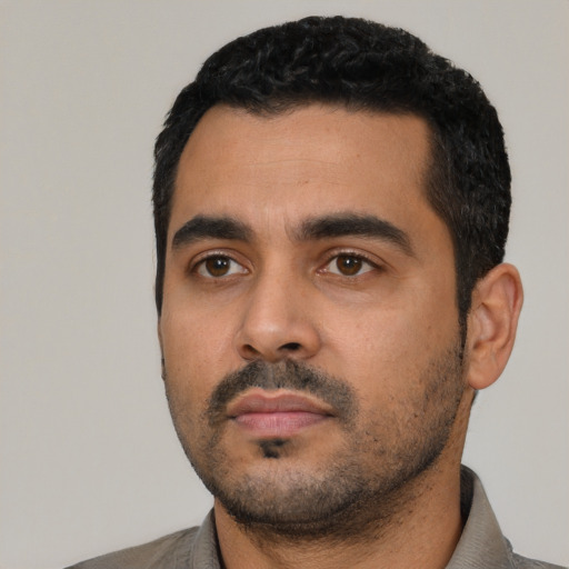 Neutral latino young-adult male with short  black hair and brown eyes