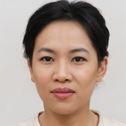 Joyful asian young-adult female with short  brown hair and brown eyes