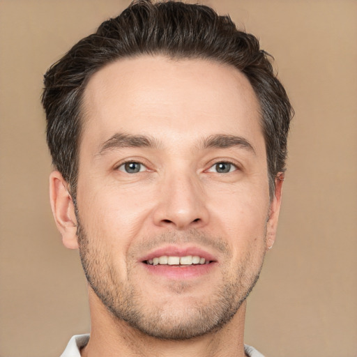 Joyful white young-adult male with short  brown hair and brown eyes